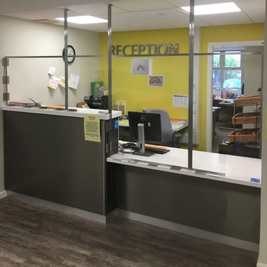Glazed screen above a reception counter in a public-facing office