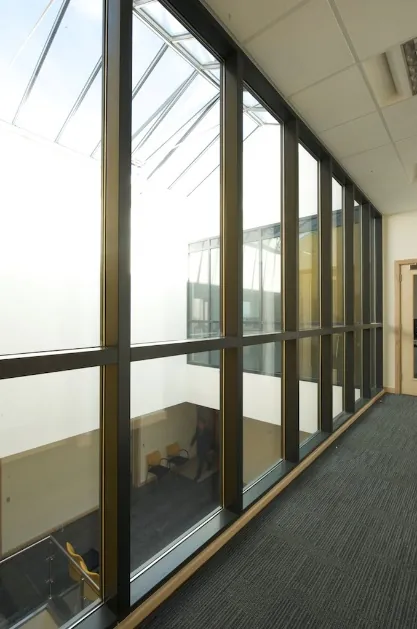 Full height glazed corridor screen beneath a rooflight